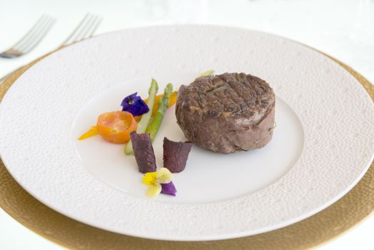 minimalistic dish steak with vegetables on a white plate