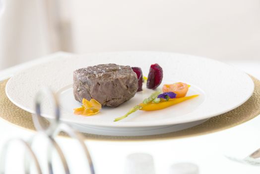 minimalistic dish steak with vegetables on a white plate