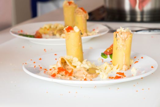 the appetizer - cheese rolls with meat and vegetables