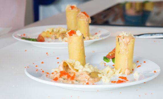 the appetizer - cheese rolls with meat and vegetables