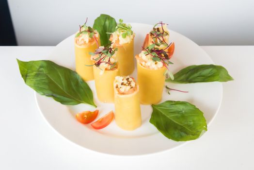 the appetizer - cheese rolls with meat and vegetables