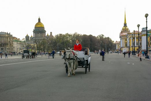 ST. PETERSBURG, RUSSIA - JANUARY 01, 2008:Carriage with horses on the Palace Square with view to the Kazan Cathedral Cathedral of Our Lady of Kazan , in Saint Petersburg, Russia