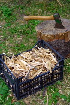 Ax in the deck, green grass and firewood