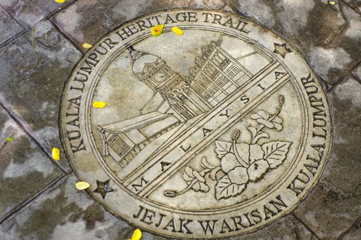 KUALA LUMPUR, MALAYSIA - JANUARY 16, 2016: a round memorial pate on ground - symbol of the city.