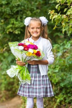 First grader with a bouquet of flowers smiling happily