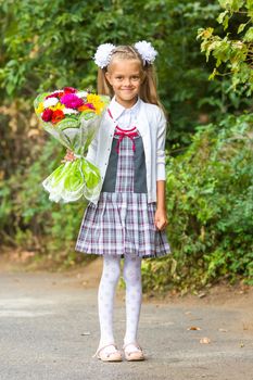 portrait of a seven-year first-grade girl with a bouquet of flowers