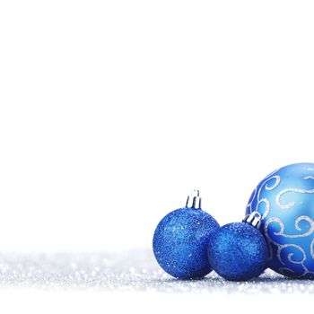 Beautiful blue Glitter christmas balls close-up on shining background