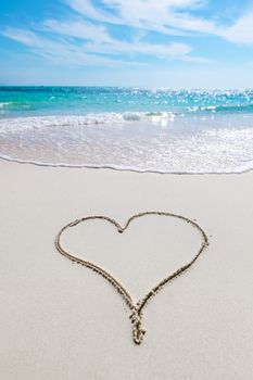 Heart drawn in the sand of tropical sea beach
