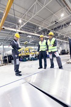 Workers working with aluminium billets at CNC machine shop