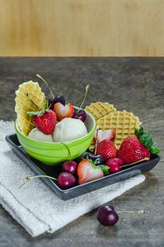 Vanilla ice cream scoops with fresh berries fruit