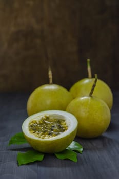 Fresh passion fruit and half over wooden background , still life