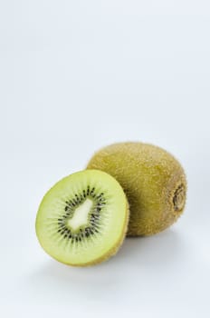 delicious whole kiwi fruit and half on white background