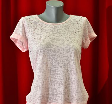 picture of a fashion summer clothes on a manequin doll on a red background