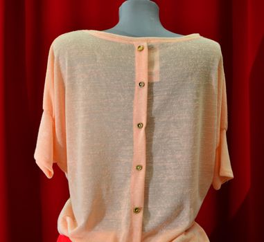 picture of a fashion summer clothes on a manequin doll on a red background