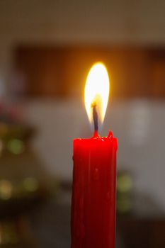 prayer red burning long candles in budist temple