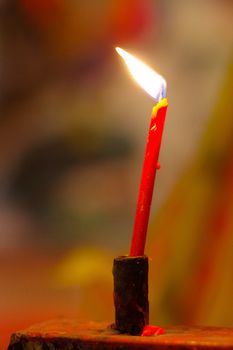 prayer red burning long candles in budist temple