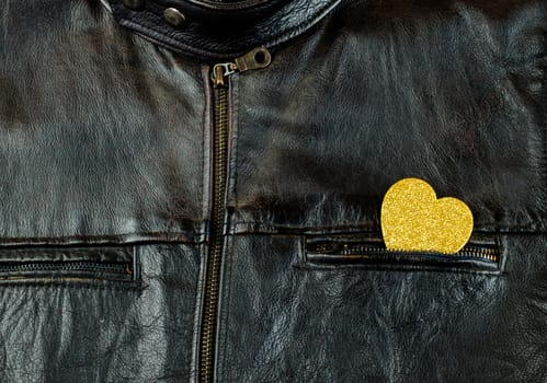 Heart of gold on old black leather jacket