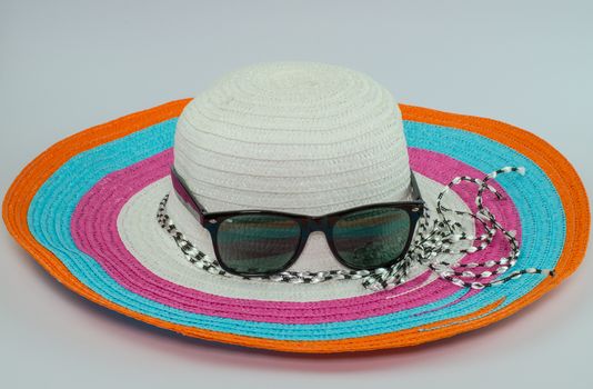 loppy beach hats sunglasses in various colors on white background