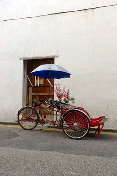 Georgetown, Penang, Malaysia - April 18, 2015: Classic local rickshaw in George Town, Penang in Malaysia