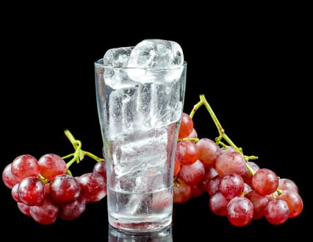 glass of wine red grape isolated on black background