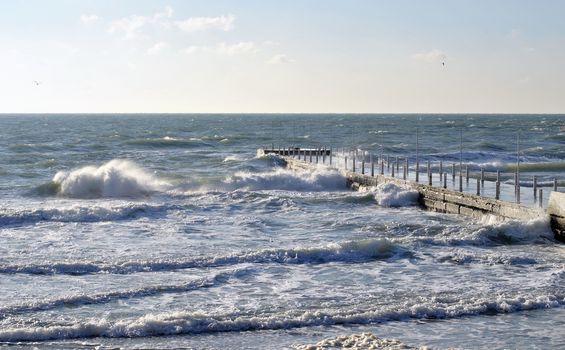 Sea wave splashing against a pier in Odessa. Black Sea.