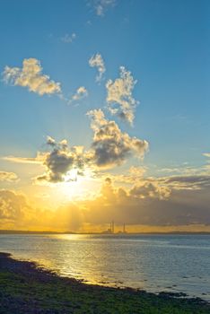 beautiful sunset over a power station on the river shannon in ireland