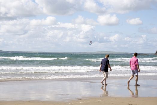 tourists watching kite surfer on beautiful waves at beach in ballybunion county kerry ireland on the wild atlantic way