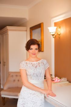 Bride standing in the room posing for the camera