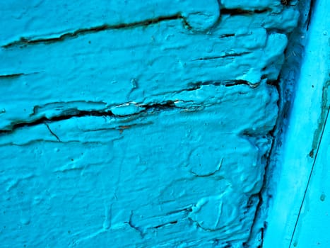 Close detailes of aged old wood panel painted in warm blue color