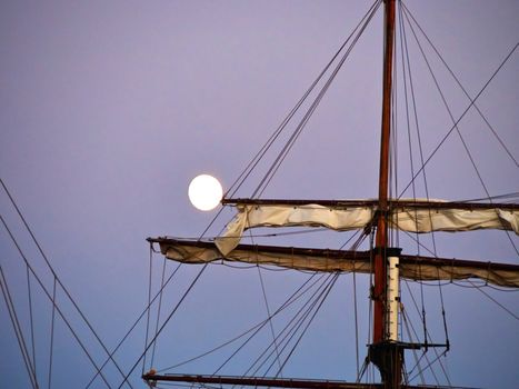 Sailing yacht tall ship illuminated by the light of a full moon great boating sailing background image