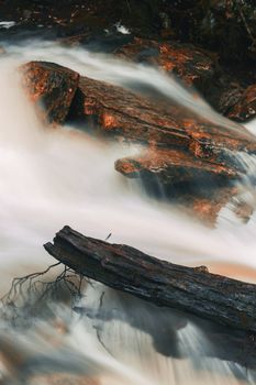 Knyvet Falls in Cradle Mountain, Tasmania after heavy rainfall with abstract red hues added.