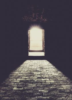 Conceptual image with a basement interior, the strong sun lights coming over the stone stairs and floor