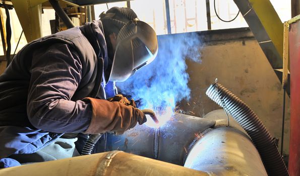 woman welder welding with mig-mag method