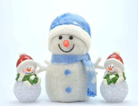 Trio of snowman with a glass ball.