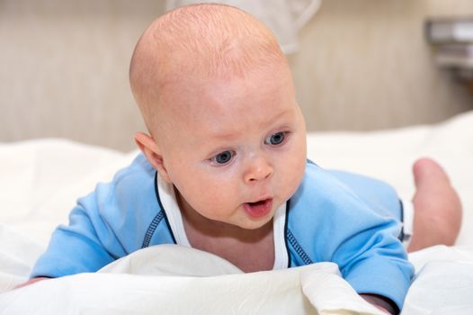 Close up shot of boy lying on stomach