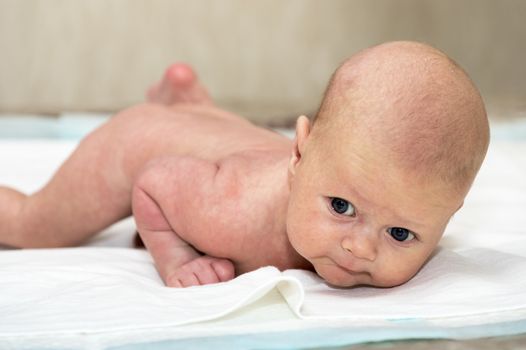 Close up shot of baby lying on stomach