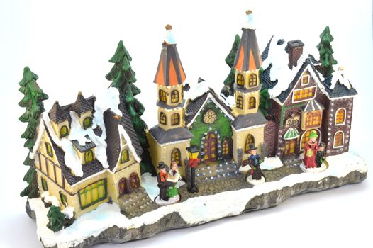Village of Christmas in plaster under the snow.
