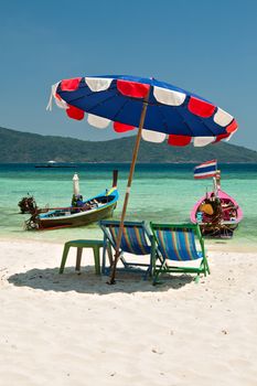 Beach umbrella and chairs in Komodo beach in Coral island, Thailand