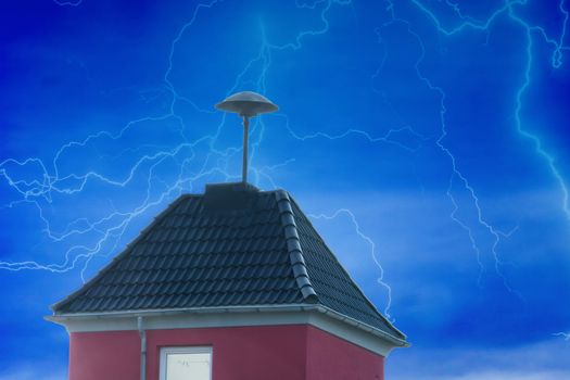 Flashes over a small residential tower with Air Raid Siren on the roof in front of dramatic sky.
