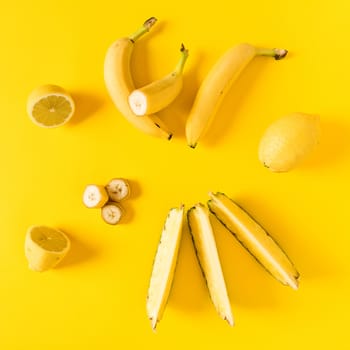 Fresh yellow toned fruits over a yellow background