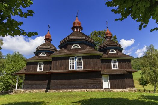 Beautiful greek catholic wooden church, UNESCO in Nizny Komarnik by day, Slovakia