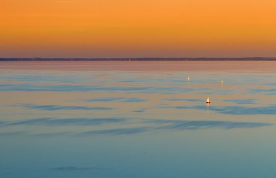 Colorful sunset over the lake and sailboats