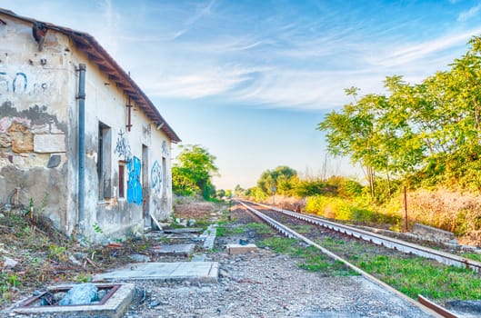 Abandoned country rail station in summer noon