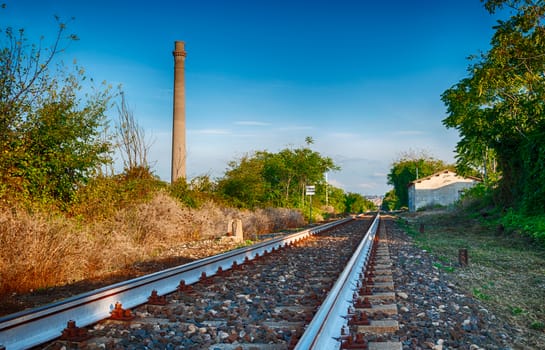 Abandoned country rail station in summer noon