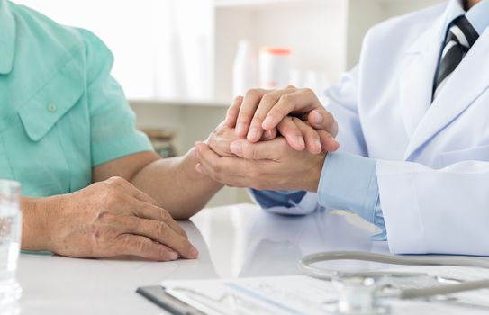 Hand of doctor reassuring him female patient. helping hand concept. medical concept.