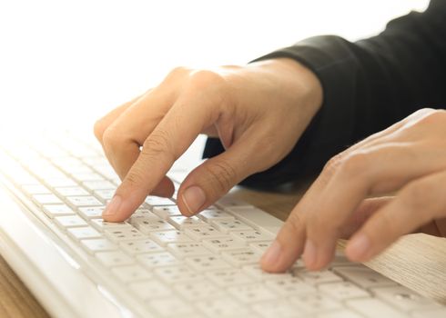 human's hands typing on computer keyboard. selective focus.