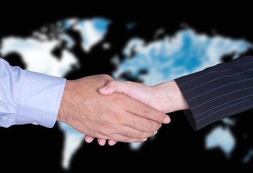 partners business handshake with blurred world map background.