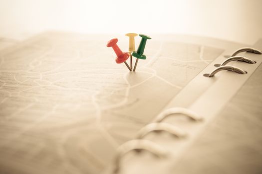 many pushpin showing the location of a destination point on a map. travel concept. goal concept. vintage style. selective focus.