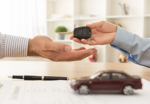 Staff handed the keys to the car to the client. Car Sales,Rental car,Car insurance concept.