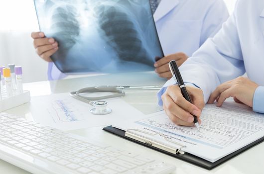 2 doctors working in office of hospital.